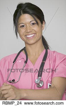 Stock Photo - portrait of an 
attractive young 
adult female in 
pink scrubs as 
she. fotosearch 
- search stock 
photos, pictures, 
images, and photo 
clipart