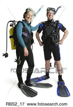 Picture - a man and a woman 
wearing wet suits 
with fins and 
snorkles stand. 
fotosearch - search 
stock photos, 
pictures, images, 
and photo clipart