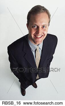 Stock Photo - a handsome young 
caucasian man 
with short brown 
hair in a dark. 
fotosearch - search 
stock photos, 
pictures, images, 
and photo clipart