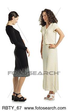 Picture - two young caucasian 
women wearing 
dresses stand 
together talking 
and. fotosearch 
- search stock 
photos, pictures, 
images, and photo 
clipart