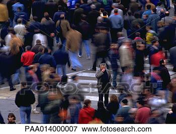 Picture - crowd walking 
by man standing 
in opposite direction, 
blurred motion. 
fotosearch - search 
stock photos, 
pictures, images, 
and photo clipart