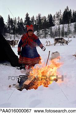 Picture - finland,  saami 
woman standing 
next to fire, 
 sled reindeer 
in. fotosearch 
- search stock 
photos, pictures, 
images, and photo 
clipart