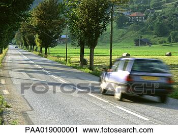 Stock Photography - fast moving car 
on road, blurred 
motion. fotosearch 
- search stock 
photos, pictures, 
images, and photo 
clipart