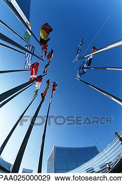 Stock Photograph - flagpoles with 
flags from different 
countries,  buildings 
in. fotosearch 
- search stock 
photos, pictures, 
images, and photo 
clipart