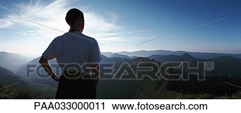 Stock Photography - france,  woman 
looking out over 
mountains at sunrise, 
 rear view. fotosearch 
- search stock 
photos, pictures, 
images, and photo 
clipart