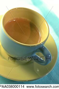 Stock Photo - cup and saucer, 
yellow and blue, 
high angle view, 
close-up, tilt. 
fotosearch - search 
stock photos, 
pictures, images, 
and photo clipart