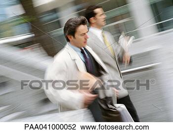Stock Photo - two businessmen 
walking outside, 
blurred motion. 
fotosearch - search 
stock photos, 
pictures, images, 
and photo clipart