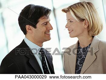 Stock Photograph - businessman and 
businesswoman 
face to face, 
smiling, close-up. 
fotosearch - search 
stock photos, 
pictures, images, 
and photo clipart