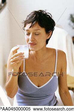 Stock Image - woman holding 
glass, eyes closed, 
waist up, close-up. 
fotosearch - search 
stock photos, 
pictures, images, 
and photo clipart