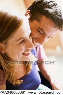 Stock Photography - woman and man 
smiling, focus 
on man in background, 
close-up. fotosearch 
- search stock 
photos, pictures, 
images, and photo 
clipart