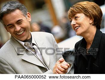 Stock Photo - man and woman 
standing laughing 
together,  woman 
looking at man. 
fotosearch - search 
stock photos, 
pictures, images, 
and photo clipart