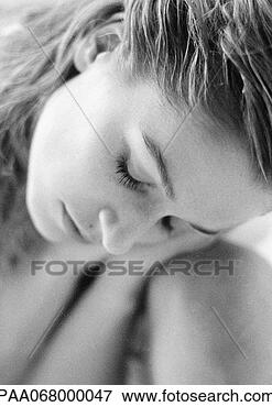 Picture - woman with eyes 
closed leaning 
head on knee, 
 close-up of face. 
fotosearch - search 
stock photos, 
pictures, images, 
and photo clipart
