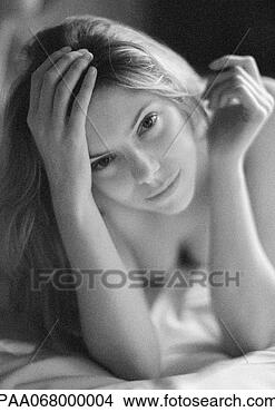 Stock Photo - woman lying on 
bed, leaning on 
elbows, black 
and white. fotosearch 
- search stock 
photos, pictures, 
images, and photo 
clipart