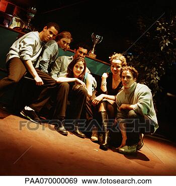 Stock Photograph - group of young 
people sitting 
in front of trophy, 
portrait. fotosearch 
- search stock 
photos, pictures, 
images, and photo 
clipart