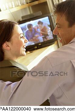 Stock Photography - couple side by 
side in front 
of television, 
 smiling,  close-up. 
fotosearch - search 
stock photos, 
pictures, images, 
and photo clipart
