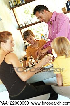 Stock Photography - parents and children 
having meal. fotosearch 
- search stock 
photos, pictures, 
images, and photo 
clipart