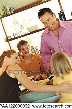 Stock Photo - parents and children 
having meal. fotosearch 
- search stock 
photos, pictures, 
images, and photo 
clipart