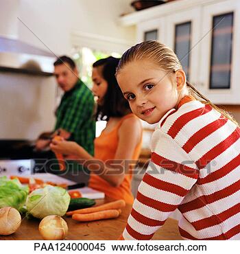 Stock Image - family cooking, 
little girl looking 
over shoulder. 
fotosearch - search 
stock photos, 
pictures, images, 
and photo clipart