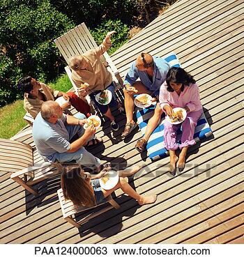 Stock Photo - grandparents, 
parents and children 
eating outside, 
elevated view. 
fotosearch - search 
stock photos, 
pictures, images, 
and photo clipart