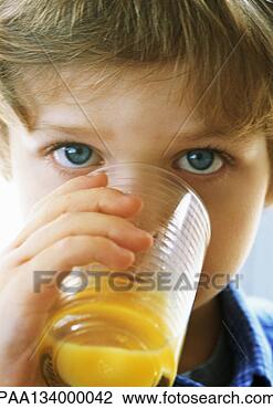 Stock Photo - little boy drinking 
juice, looking 
at camera, portrait, 
close-up. fotosearch 
- search stock 
photos, pictures, 
images, and photo 
clipart