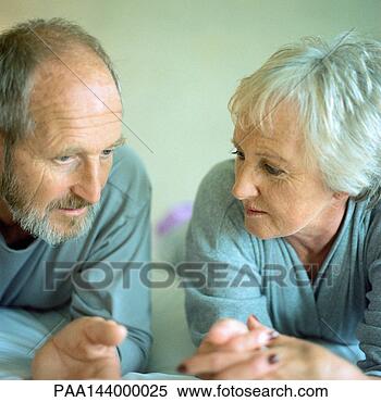 Stock Image - mature couple 
lying side by 
side. fotosearch 
- search stock 
photos, pictures, 
images, and photo 
clipart