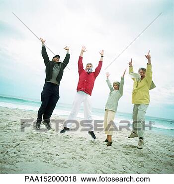 Stock Photo - mature group on 
beach, jumping 
in air, looking 
into camera. fotosearch 
- search stock 
photos, pictures, 
images, and photo 
clipart
