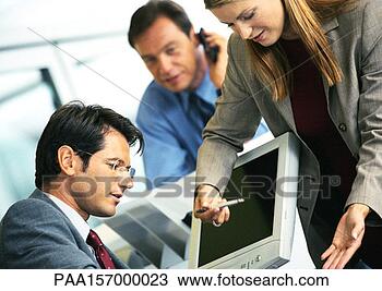 Stock Photo - woman pointing 
to computer screen, 
 man sitting in 
front of computer. 
fotosearch - search 
stock photos, 
pictures, images, 
and photo clipart