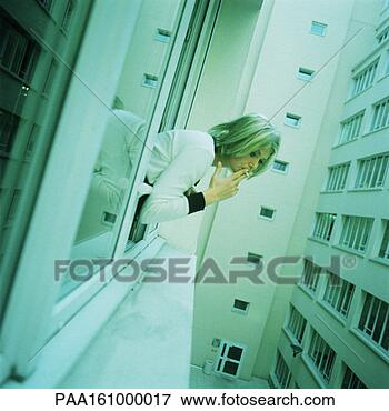 Picture - woman leaning 
out of window, 
smoking, tilt. 
fotosearch - search 
stock photos, 
pictures, images, 
and photo clipart