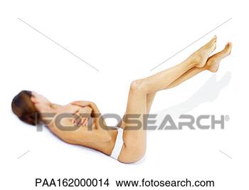 Stock Photo - woman lying down 
with legs up, 
covering breasts, 
semi-naked. fotosearch 
- search stock 
photos, pictures, 
images, and photo 
clipart
