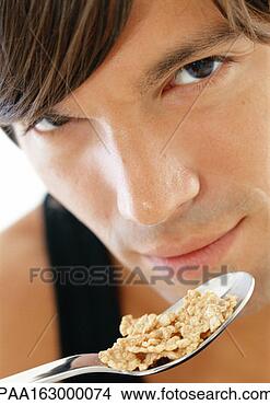 Stock Photo - young man eating 
cereal, close-up. 
fotosearch - search 
stock photos, 
pictures, images, 
and photo clipart