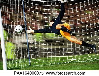 Stock Image - goal keeper reaching 
for soccer ball. 
fotosearch - search 
stock photos, 
pictures, images, 
and photo clipart