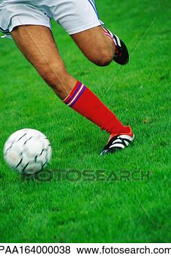 Stock Photo - soccer player's 
legs, running 
with ball, low 
section. fotosearch 
- search stock 
photos, pictures, 
images, and photo 
clipart