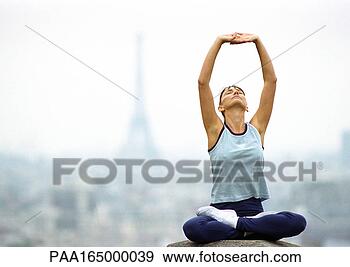 Stock Photograph - paris,  france, 
 woman sitting 
with legs crossed 
and arms stretching. 
fotosearch - search 
stock photos, 
pictures, images, 
and photo clipart