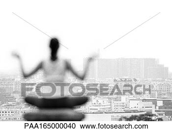 Stock Photography - woman sitting 
in yoga position, 
 overlooking city, 
 rear view. fotosearch 
- search stock 
photos, pictures, 
images, and photo 
clipart