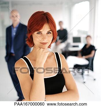 Stock Photography - businesspeople 
 in office, focus 
on woman in foreground, 
portrait. fotosearch 
- search stock 
photos, pictures, 
images, and photo 
clipart