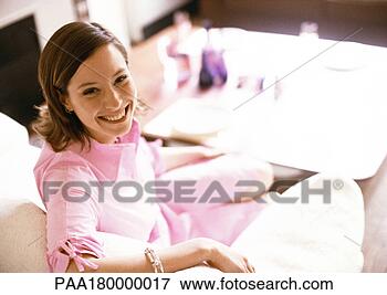 Picture - woman sitting 
on sofa, smiling, 
portrait. fotosearch 
- search stock 
photos, pictures, 
images, and photo 
clipart