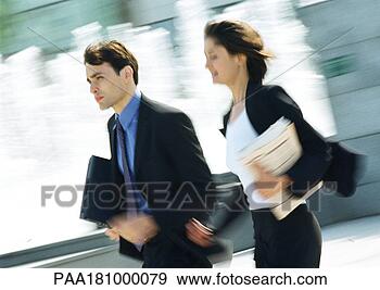 Stock Photograph - businessman and 
woman walking 
outdoors, blurred 
motion. fotosearch 
- search stock 
photos, pictures, 
images, and photo 
clipart