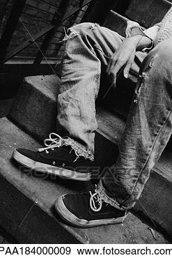 Stock Photograph - person sitting 
on stairs, low 
section, b&w. 
fotosearch - search 
stock photos, 
pictures, images, 
and photo clipart