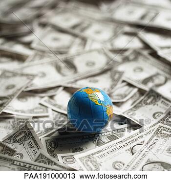 Stock Photo - small world globe 
on top of us dollars. 
fotosearch - search 
stock photos, 
pictures, images, 
and photo clipart