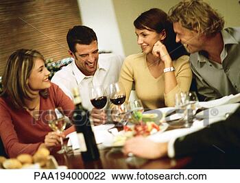 Stock Photo - group of young 
people around 
table, drinking 
wine and laughing. 
fotosearch - search 
stock photos, 
pictures, images, 
and photo clipart