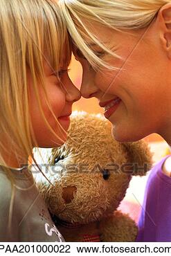 Stock Photo - woman and little 
girl, nose to 
nose, teddy bear 
in background. 
fotosearch - search 
stock photos, 
pictures, images, 
and photo clipart