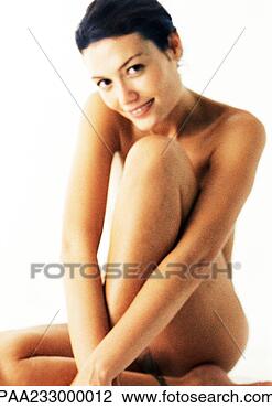 Stock Photo - nude woman sitting 
with one knee 
up in front of 
chest,  smiling 
at. fotosearch 
- search stock 
photos, pictures, 
images, and photo 
clipart