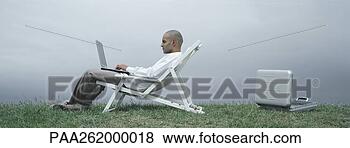 Stock Photo - man sitting in 
lounge chair with 
laptop on lap, 
 side view,  open. 
fotosearch - search 
stock photos, 
pictures, images, 
and photo clipart
