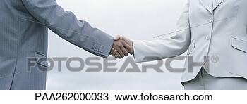 Stock Photo - woman and man 
in suits shaking 
hands,  mid-section 
with sky in. fotosearch 
- search stock 
photos, pictures, 
images, and photo 
clipart
