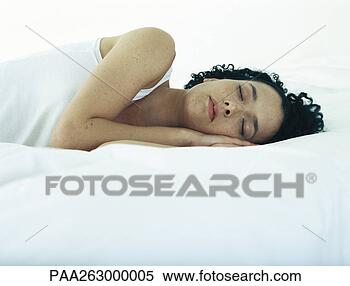 Stock Image - woman lying on 
side on bed with 
hands under head 
and eyes closed. 
fotosearch - search 
stock photos, 
pictures, images, 
and photo clipart