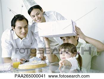 Stock Photography - boy and girl with 
parents having 
birthday party. 
fotosearch - search 
stock photos, 
pictures, images, 
and photo clipart
