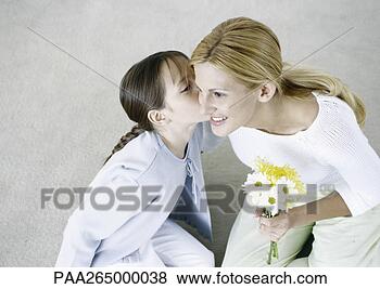 Stock Photo - woman holding 
bouquet of flowers, 
girl kissing her 
cheek. fotosearch 
- search stock 
photos, pictures, 
images, and photo 
clipart