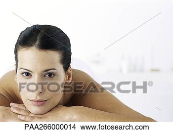 Stock Photo - woman with bare 
shoulders resting 
head on hands, 
looking at camera. 
fotosearch - search 
stock photos, 
pictures, images, 
and photo clipart