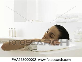 Stock Photo - woman in bath 
resting head on 
edge of tub. fotosearch 
- search stock 
photos, pictures, 
images, and photo 
clipart