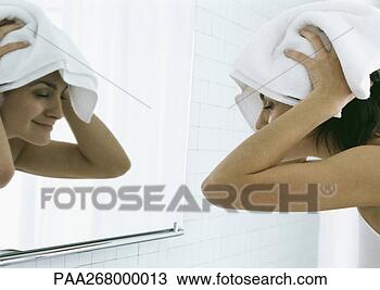 Stock Photo - woman drying hair 
with towel in 
front of mirror. 
fotosearch - search 
stock photos, 
pictures, images, 
and photo clipart